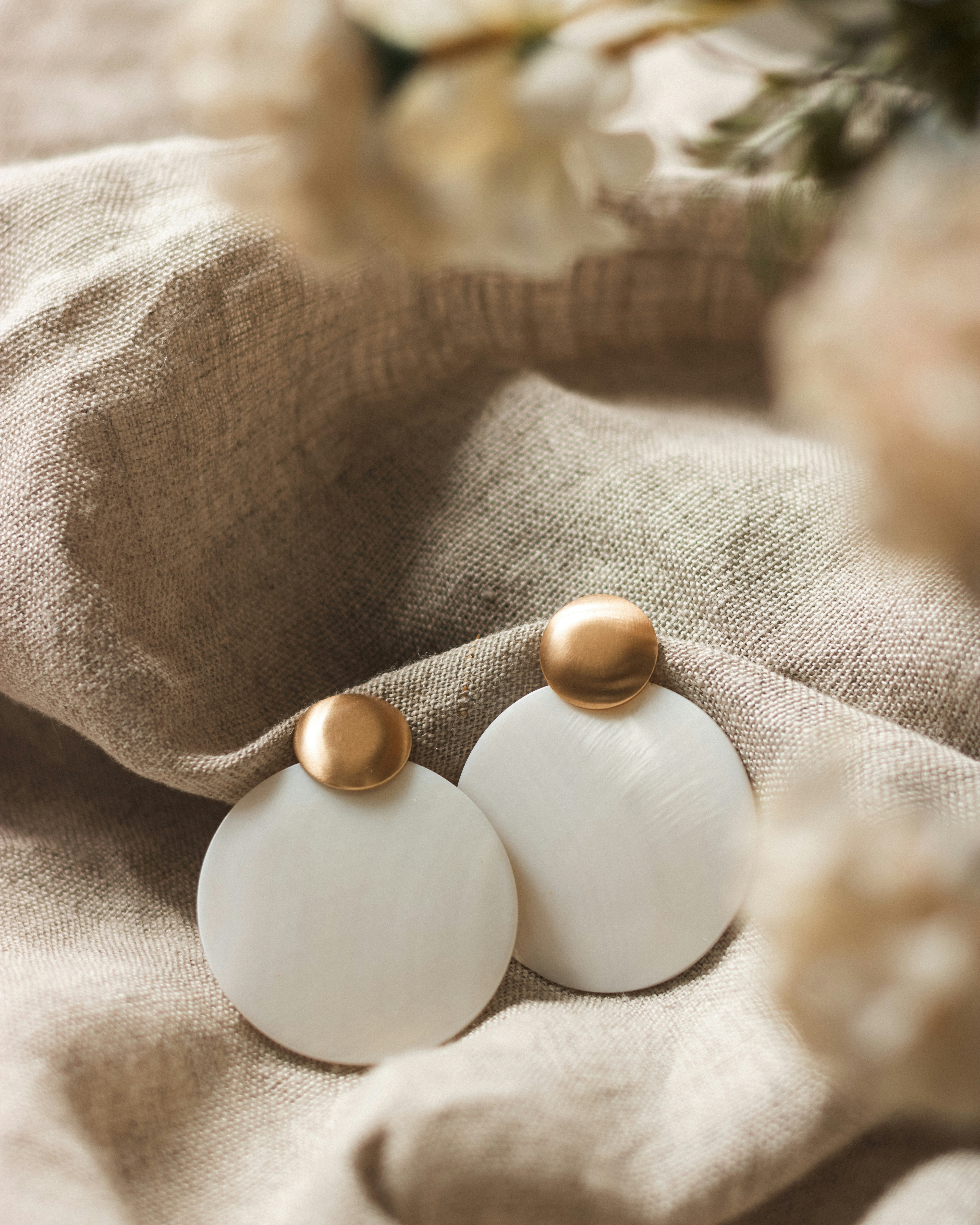 two drop down earrings on ear